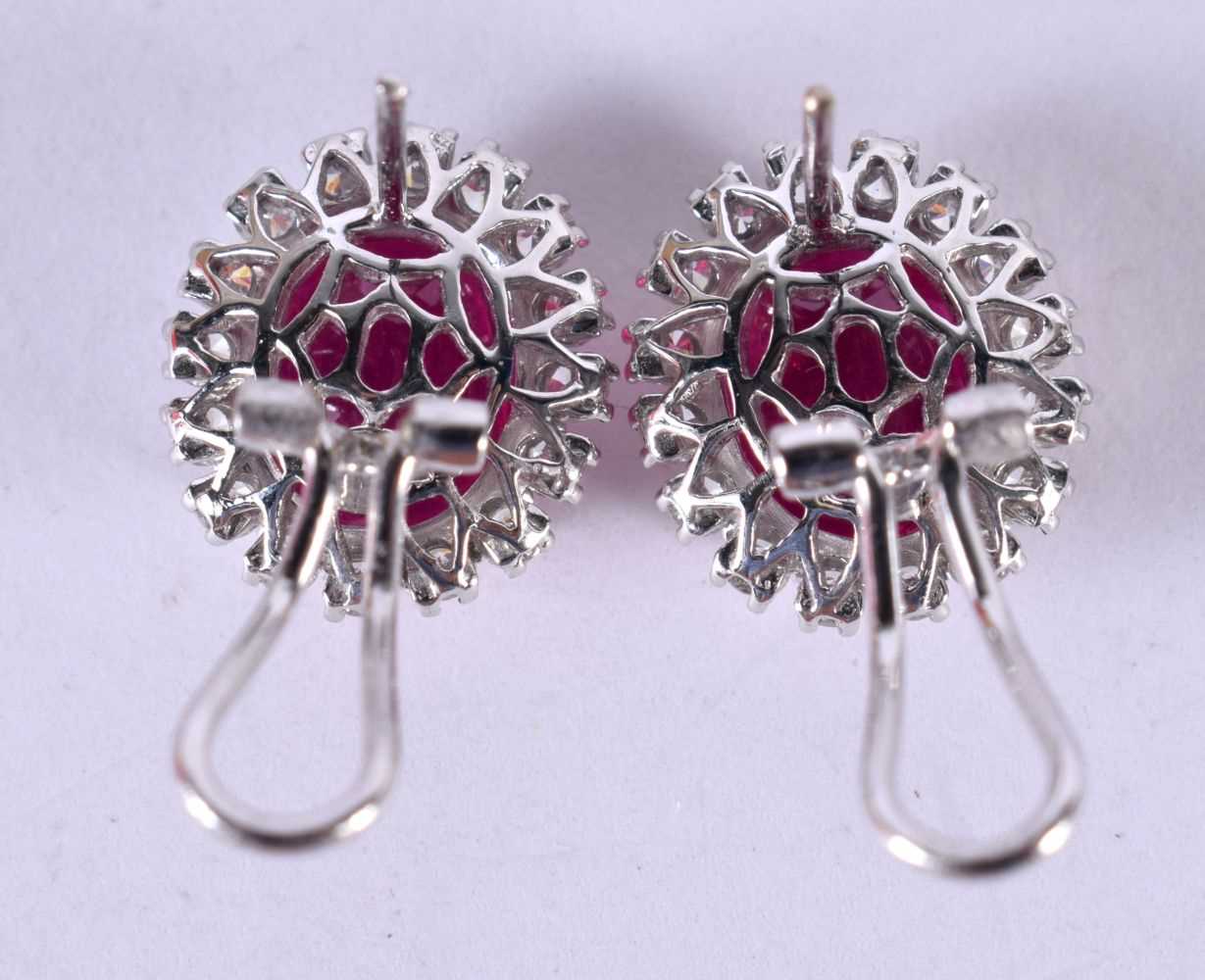 A PAIR OF 14CT WHITE GOLD EARRINGS SET WITH A RUBY SURROUNDED BY A DIAMOND BEZEL. STAMPED 14k 585, - Image 3 of 3