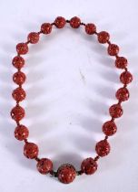 A CHINESE CARVED CINNABAR LACQUER NECKLACE. 27 grams. 47 cm long.