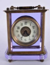 A VERY UNUSUAL EARLY 20TH CENTURY FRENCH BRASS AND AMETHYST GLASS CLOCK with circular enamel dial.