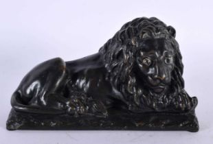 A LOVELY EARLY 19TH CENTURY REGENCY BRONZE MODEL OF A recumbent LION modelled upon a naturalistic