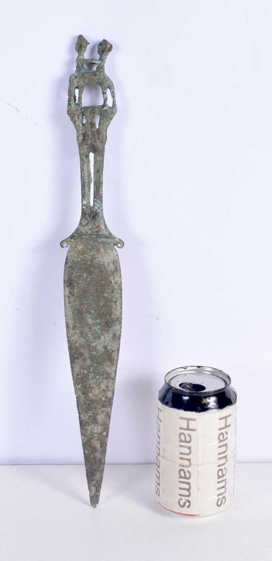 A Central Asian bronze dagger, the handle formed as two males. 39 sm.