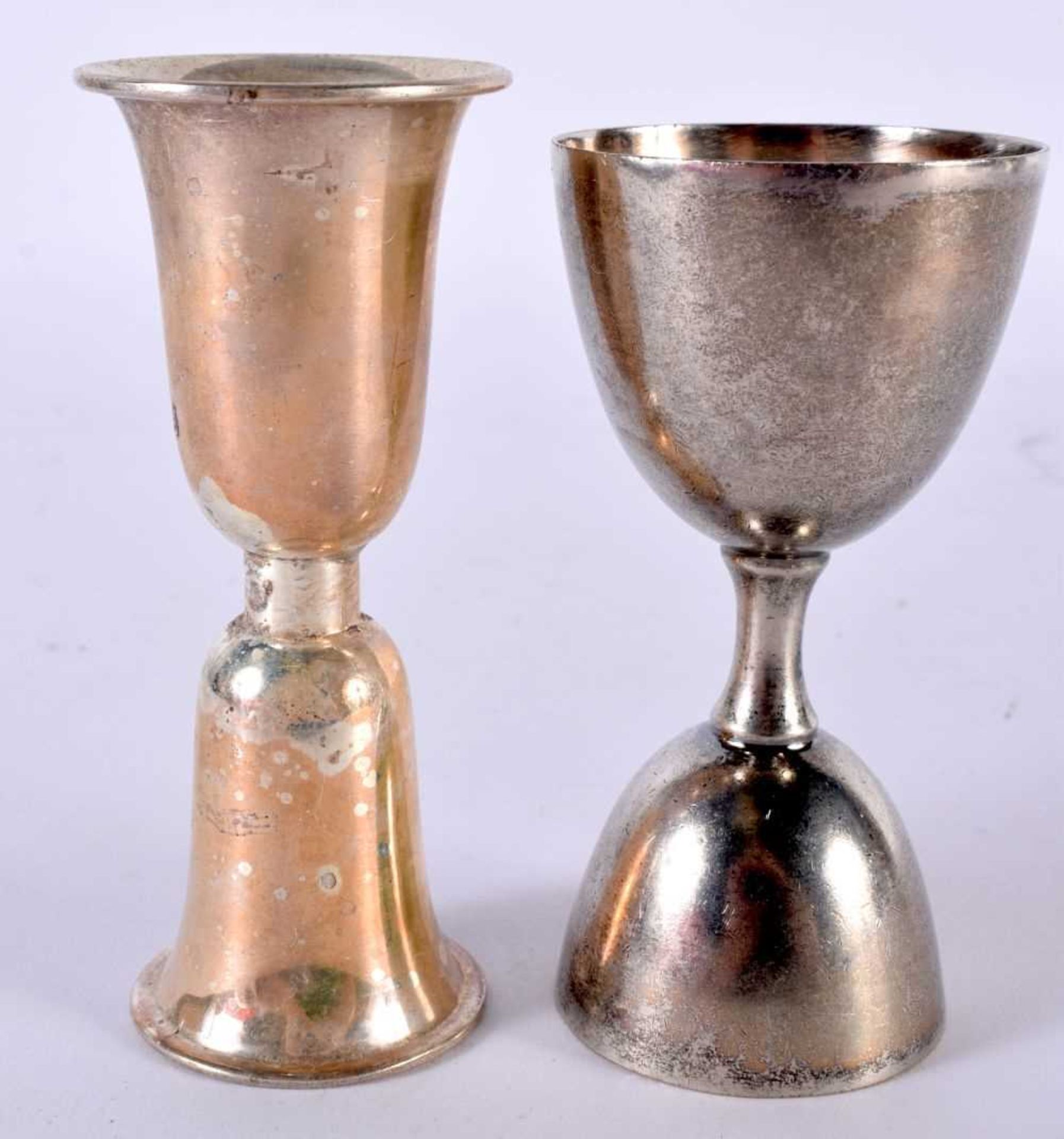 TWO WHITE METAL DRINKS MEASURE CUPS. Largest 10.9cm x 4.6 cm (2)