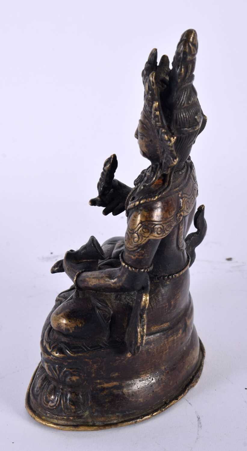 A 19TH CENTURY TIBETAN NEPALESE BRONZE FIGURE OF A SEATED BUDDHA modelled upon a triangular lotus - Image 2 of 4