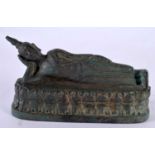 A 19TH CENTURY SOUTH EAST ASIAN THAI BRONZE FIGURE OF A RECLINING BUDDHA modelled upon an oval base.