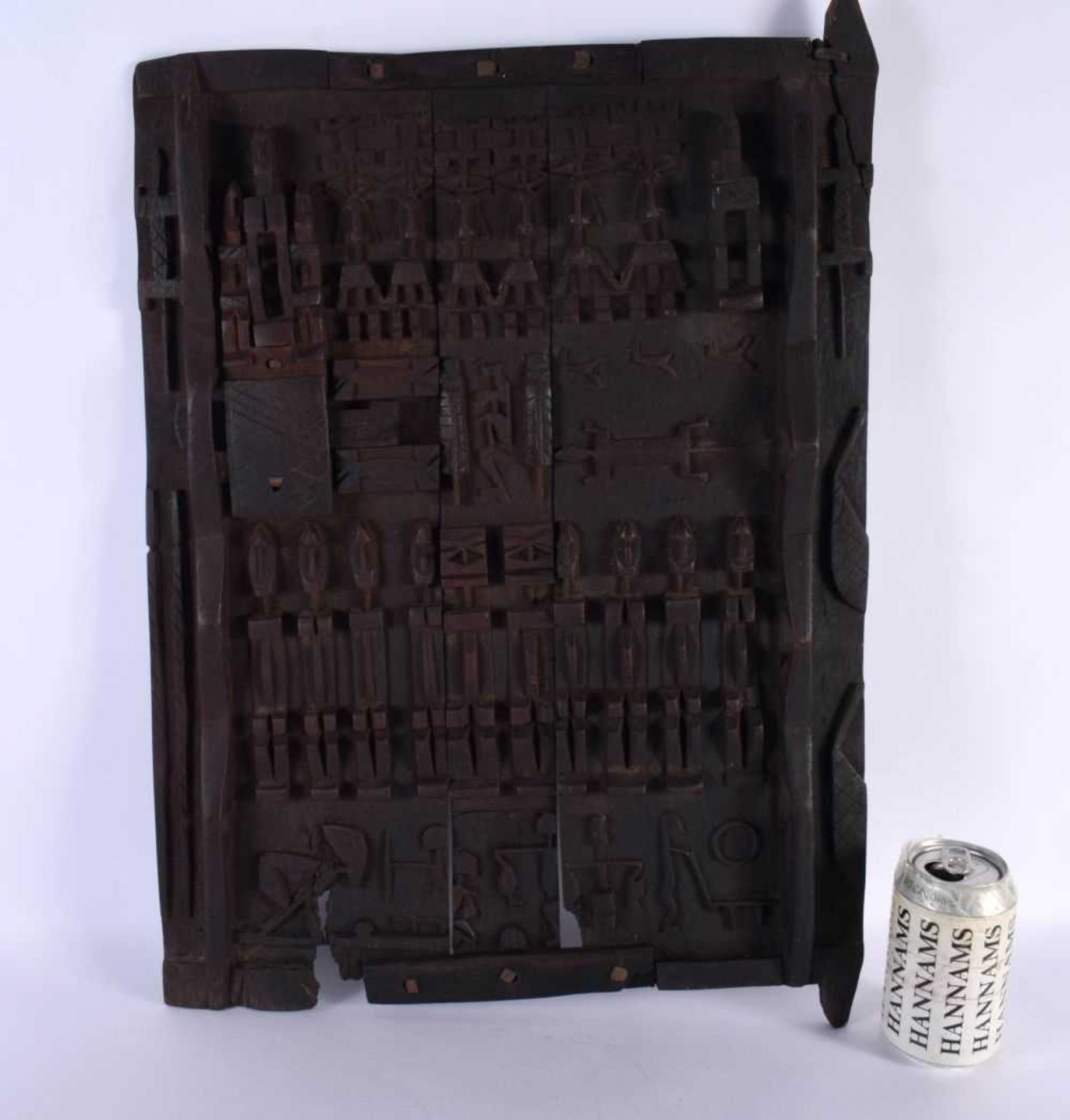 AN AFRICAN TRIBAL CARVED WOOD DOGON DOOR depicting figures and animals. 52 cm x 38 cm.