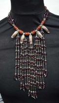 A beaded necklace with metal leaf decoration . 40 cm
