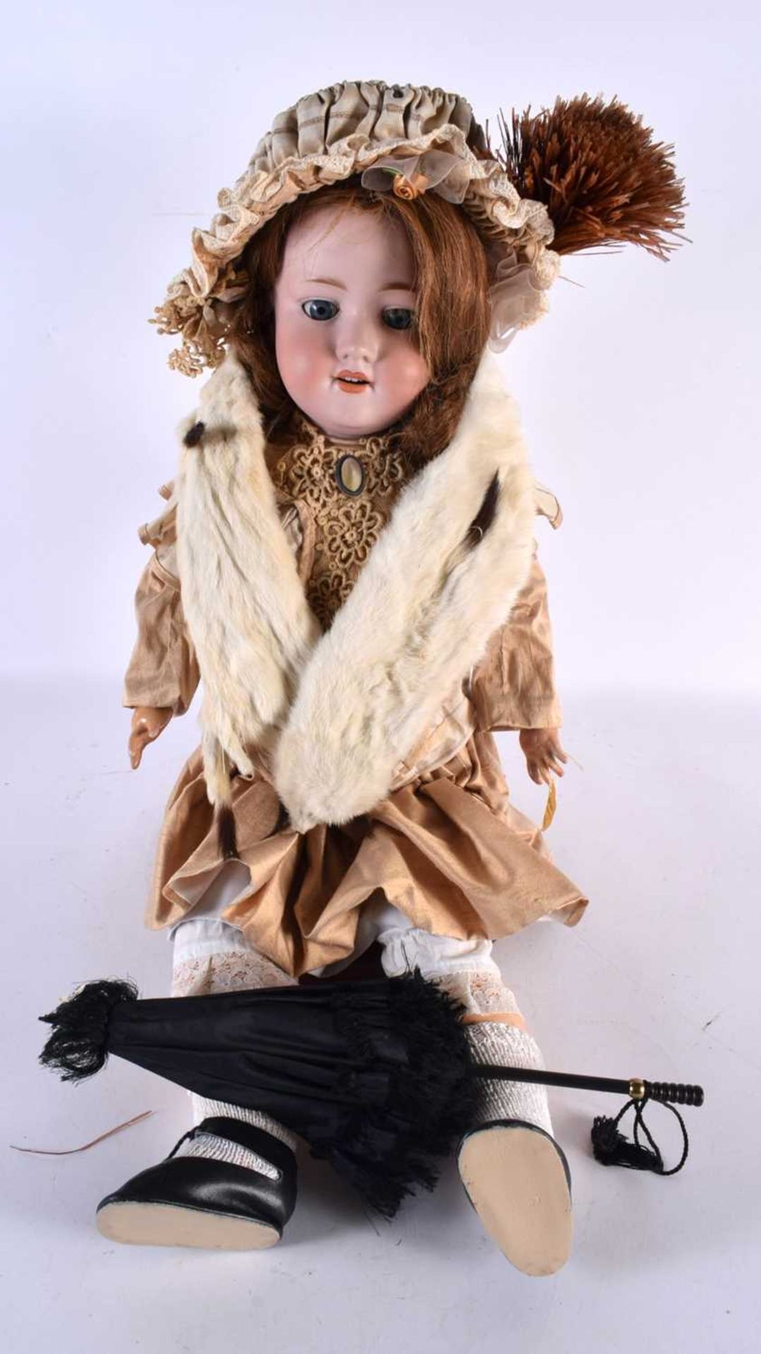 A FINE ARMAND MARSEILLE BISQUE HEADED PORCELAIN DOLL wearing an embroidered neck collar and beige