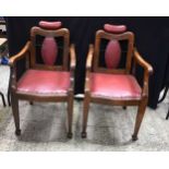 A pair of leather upholstered adjustable Antique barbers chairs