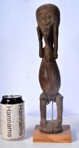 An early carved wood Dogun figure 35 cm.