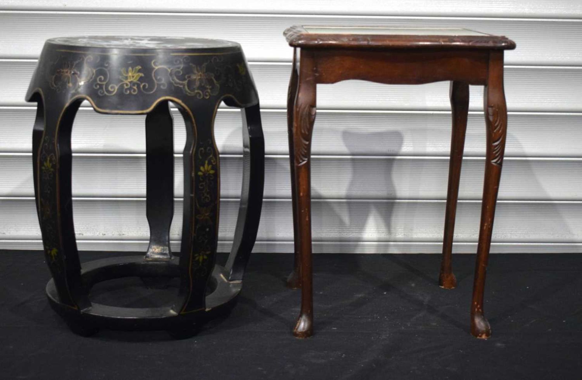 A Black lacquered stool with a mother of Pearl inlaid top together with a leather topped side table.