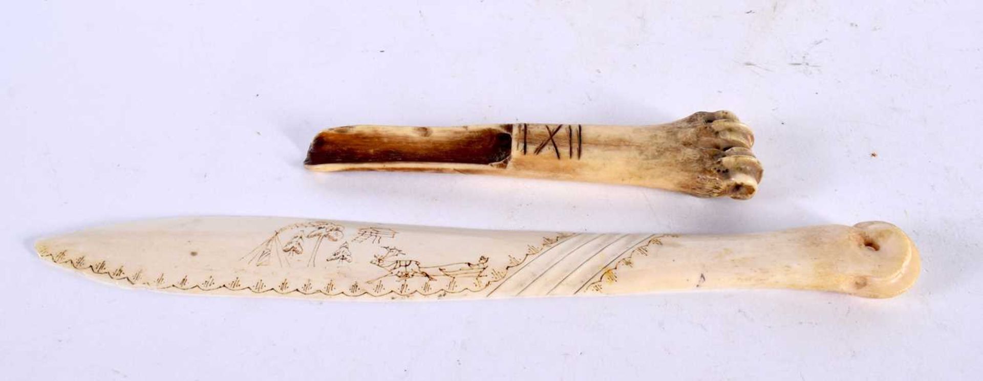 AN ANTIQUE CARVED BONE TRIBAL MARROW SCOOP together with a carved scrimshaw letter opener. 52 grams.