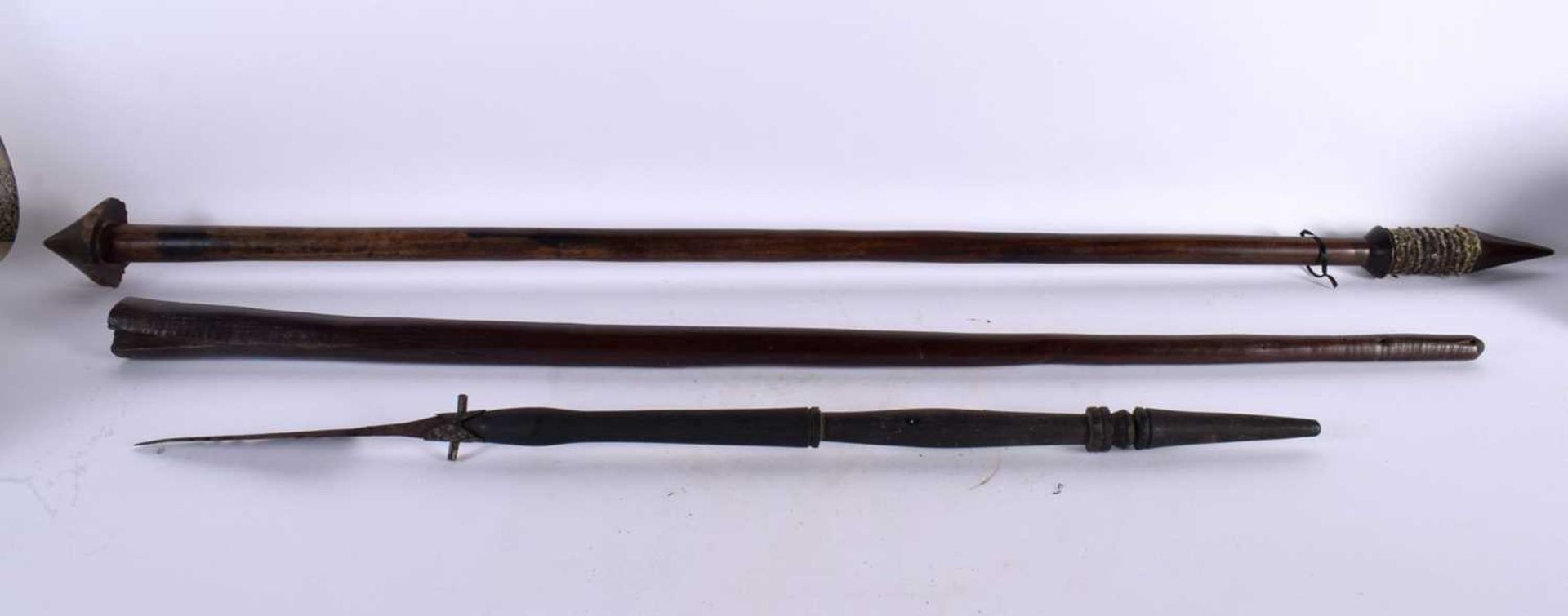 TWO ANTIQUE TRIBAL FIJIAN IRON WOOD STAFFS together with another tribal spear. Largest 110 cm