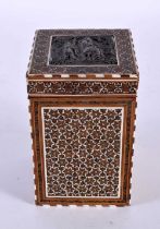 A 19TH CENTURY MIDDLE EASTERN SILVER INLAID MICRO MOSAIC TEA CADDY AND COVER decorated with figures.
