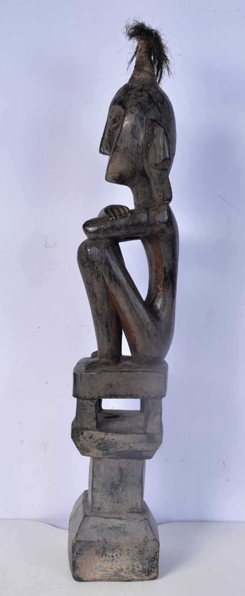 A carved wooden headhunter/ancestor figure from the Leti Islands (Indonesia), seated on a house - Image 4 of 5