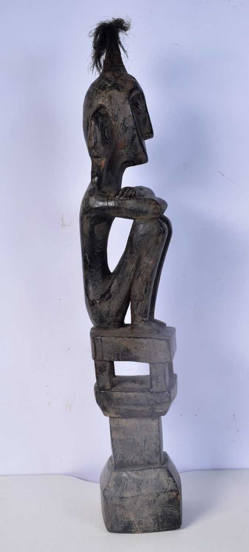 A carved wooden headhunter/ancestor figure from the Leti Islands (Indonesia), seated on a house - Image 2 of 5