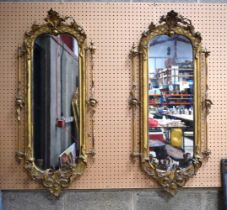 A pair of late 18/19th century giltwood and plaster old mirrored glass. 118 x 53cm.