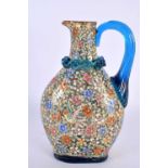 AN ART NOUVEAU ENAMELLED BLUE GLASS AESTHETIC JUG decorated in relief with birds amongst foliage. 19
