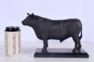 A bronze bull mounted on a marble plinth 17 x 26 cm.