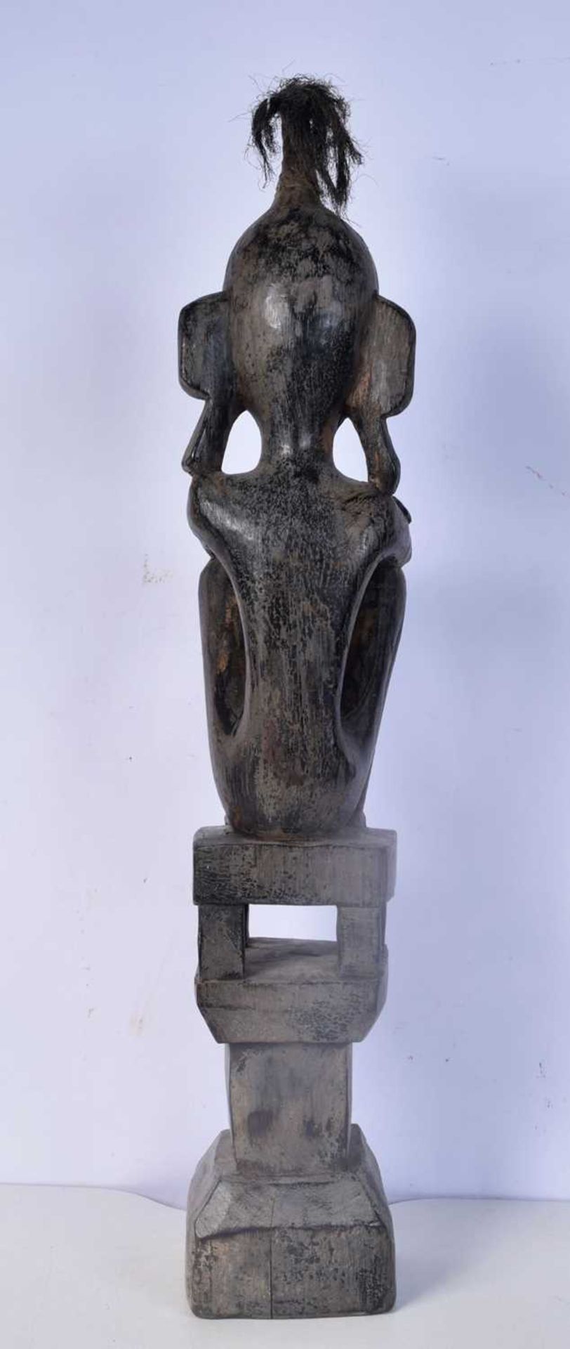 A carved wooden headhunter/ancestor figure from the Leti Islands (Indonesia), seated on a house - Image 3 of 5