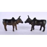 A PAIR OF 18TH/19TH CENTURY INDIAN BRONZE FIGURES OF NANDI BULLS modelled roaming. 11cm x 8 cm.