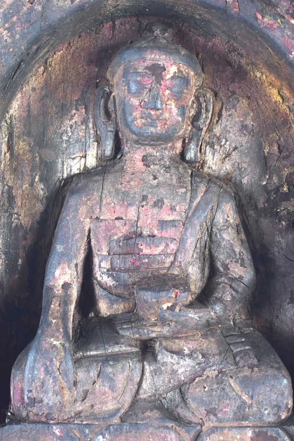 A 19TH CENTURY INDIAN TIBETAN NEPALESE CARVED WOOD BUDDHIST SHRINE modelled as a seated buddha. 23 - Image 3 of 4