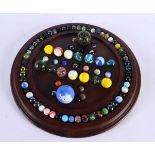 A SOLITAIRE MARBLE BOARD with marbles. 32 cm diameter. (qty)