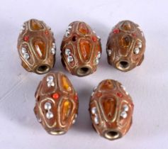 FIVE UNUSUAL PEARL CORAL NUT AND AMBER BEADS possibly Ottoman. 18.6 grams. 2 cm x 1.25 cm. (5)