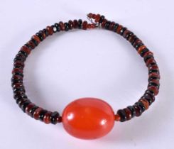 A CHERRY AMBER TYPE NECKLACE. 51.7 grams. Largest bead 4 cm x 3 cm.