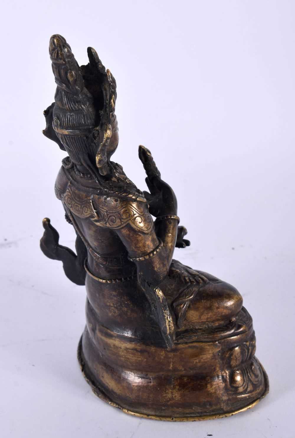 A 19TH CENTURY TIBETAN NEPALESE BRONZE FIGURE OF A SEATED BUDDHA modelled upon a triangular lotus - Image 3 of 4