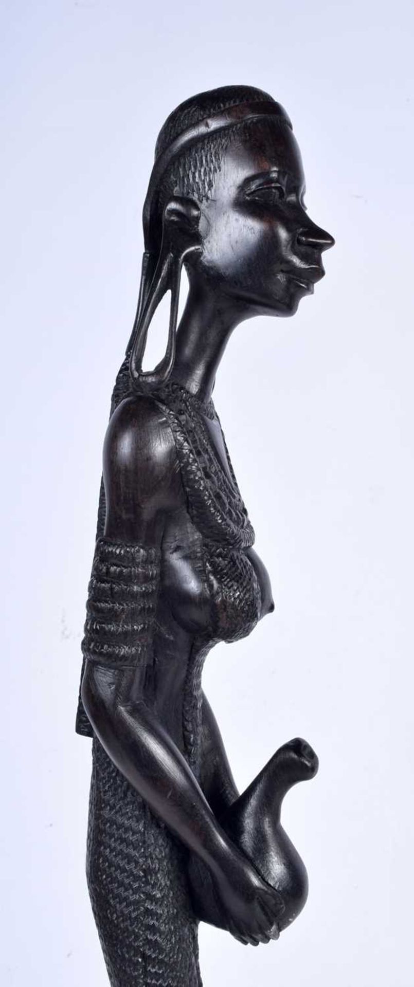 A 20th century South African intricately carved hardwood figure of an woman carrying a water gourd - Image 3 of 5