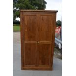 An oak wardrobe 193 x 107 x 56cm.