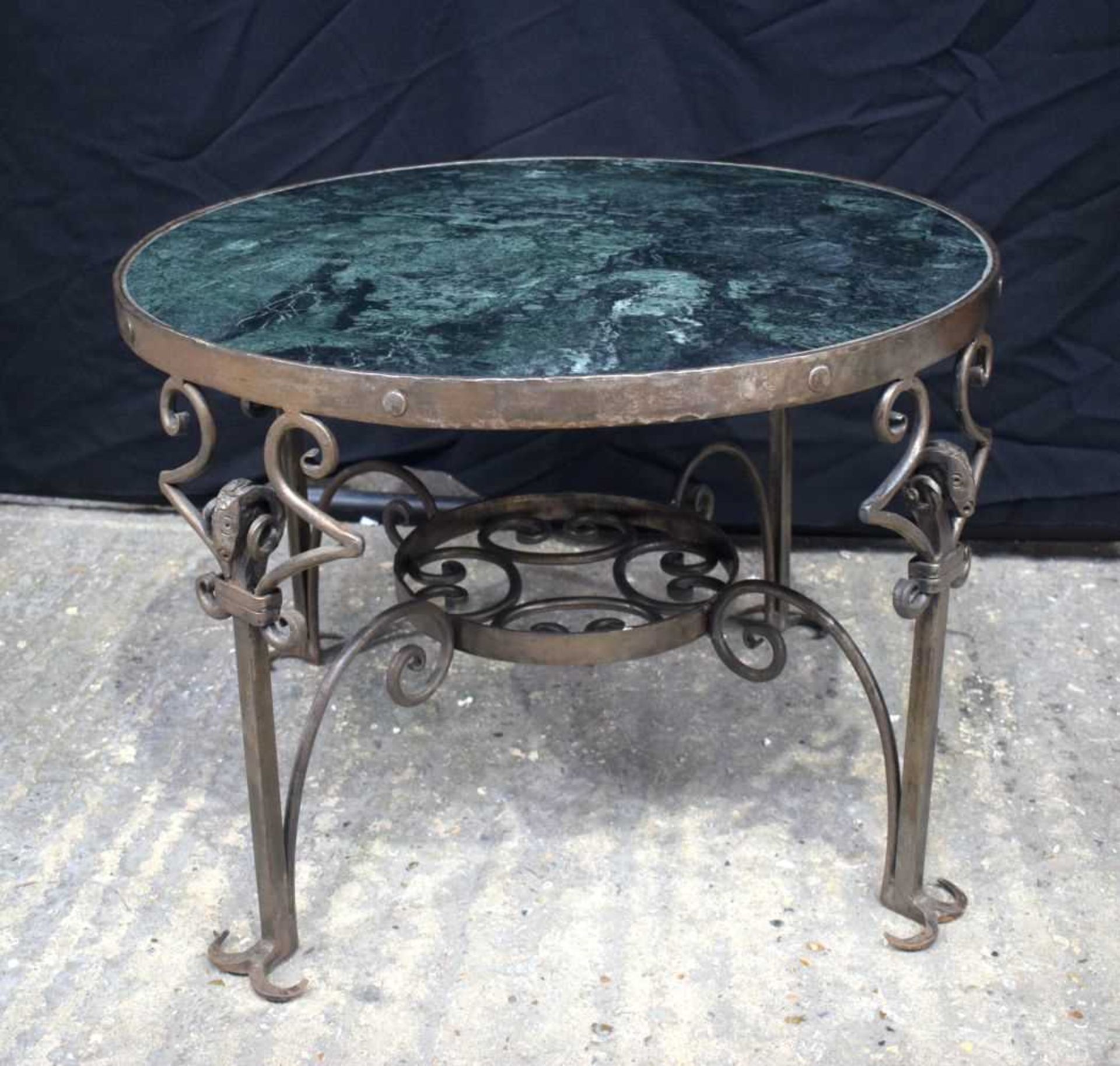 A cast iron framed Marble top coffee table 45 x 63 cm.