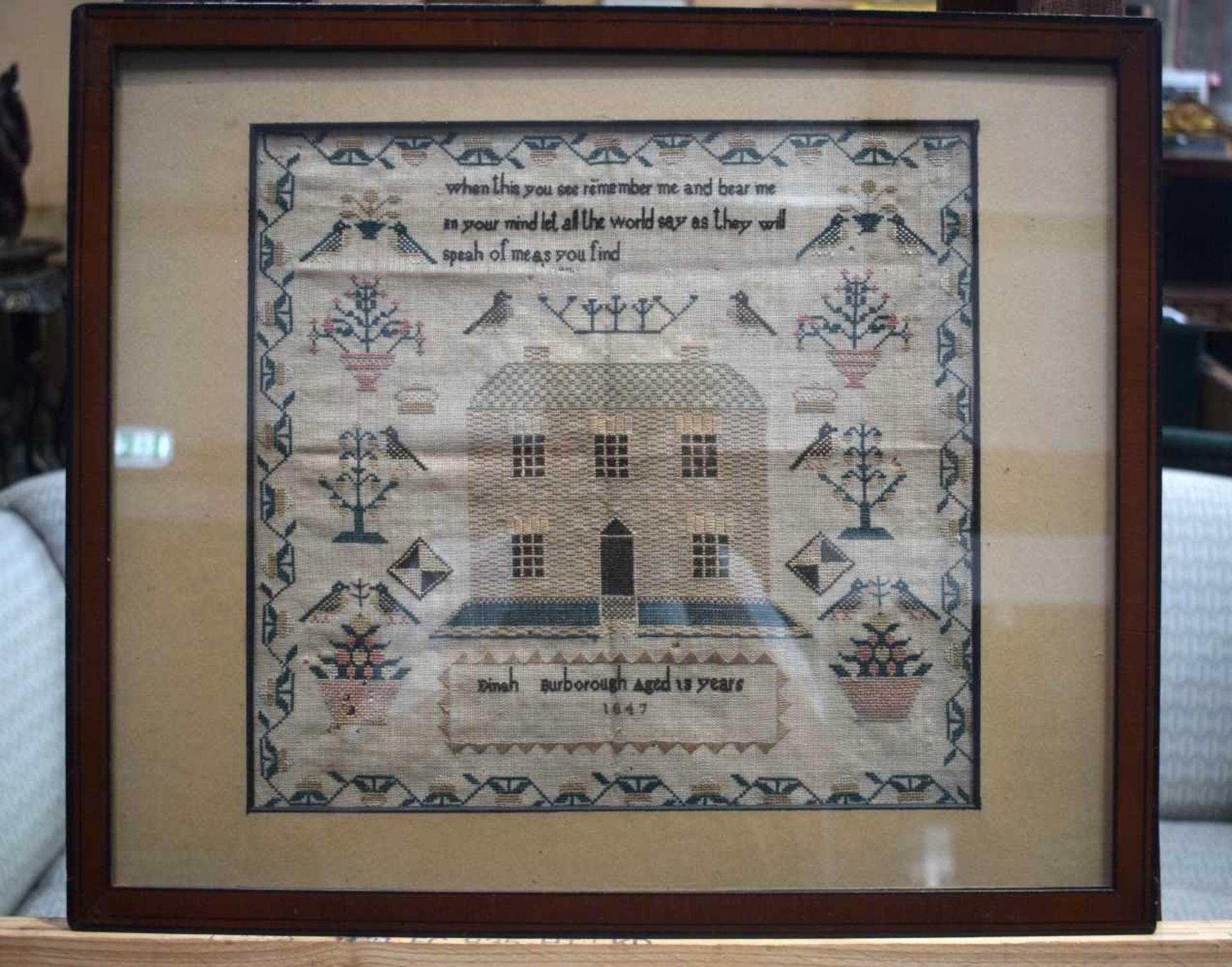 A framed sampler dated 1847 30 x 32 cm