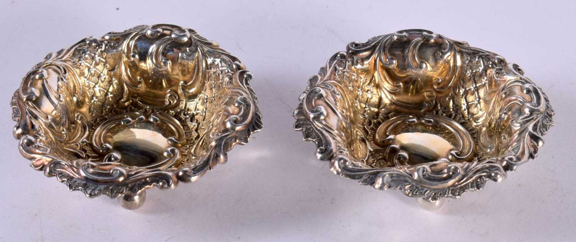 A PAIR OF VICTORIAN SILVER SALTS WITH GILT INTERIOR. Hallmarked Chester 1896, 6.2 cm x 1.9cm,