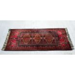 An Oriental rug 169 x 70 cm .