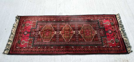 An Oriental rug 169 x 70 cm .