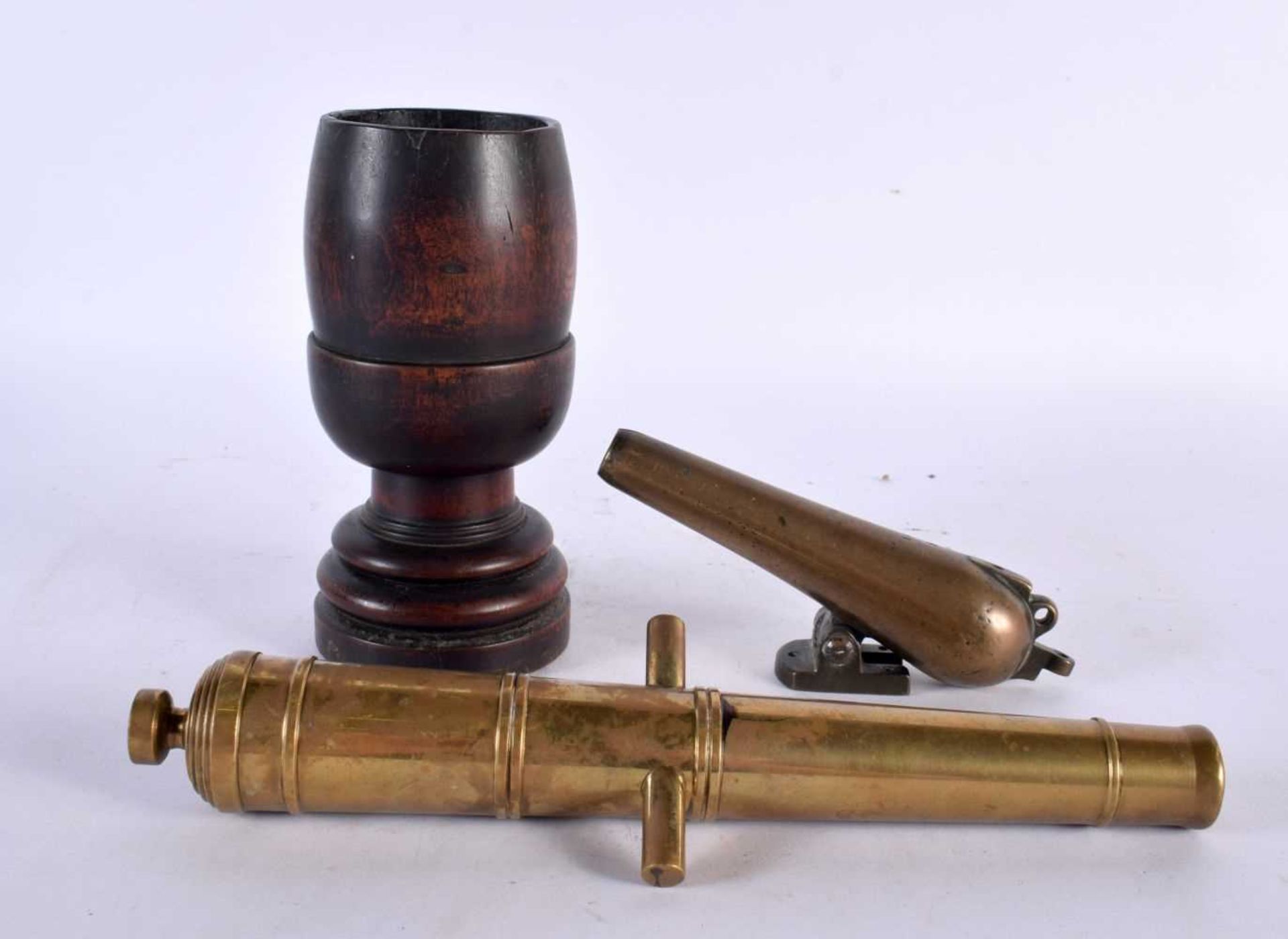 TWO ANTIQUE BRONZE CANNONS together with a treen mortar. Largest 16 cm high. (3)