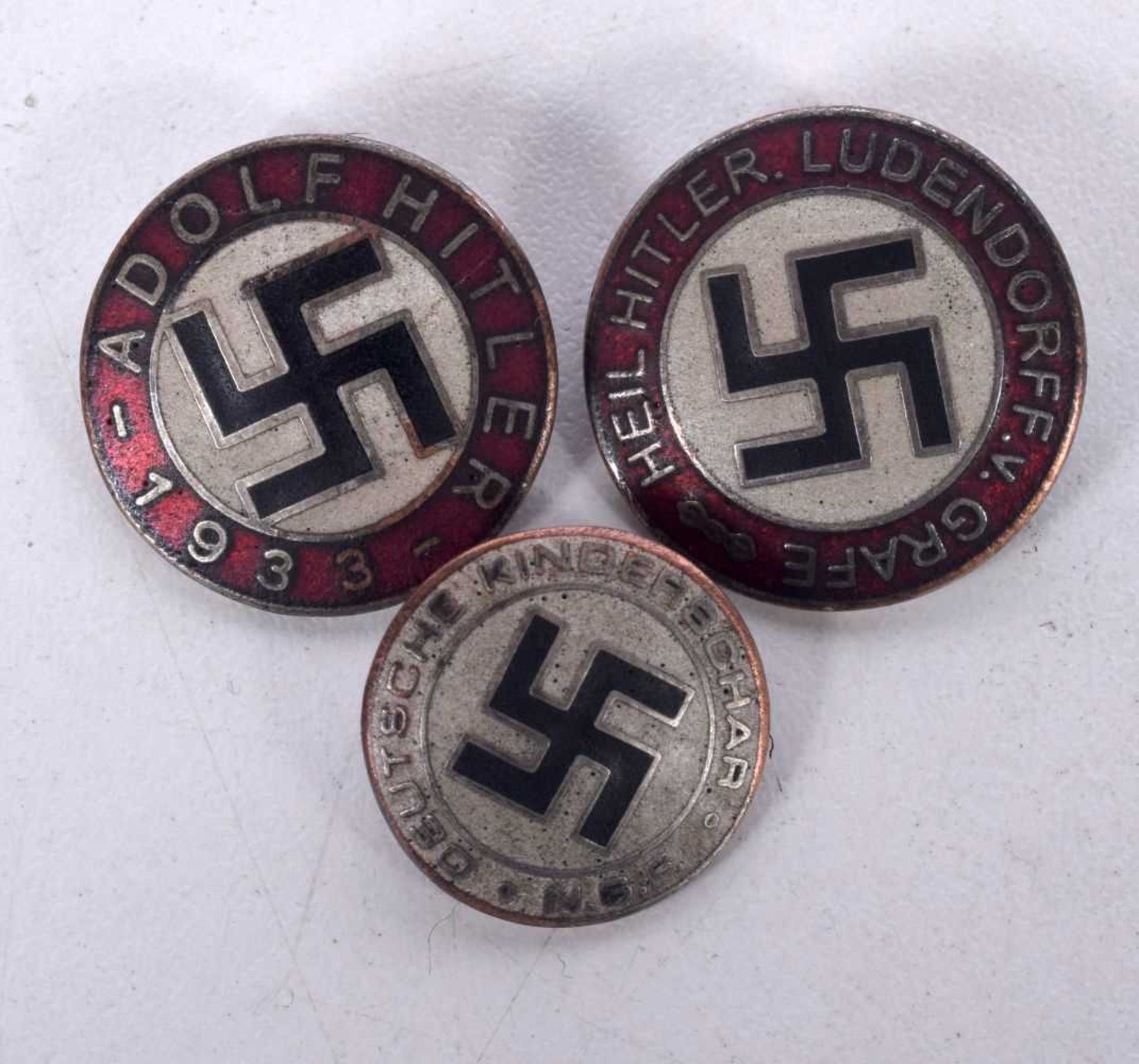 THREE GERMAN MILITARY ENAMELLED BADGES. 13.2 grams. 2.25 cm diameter. (3)