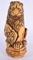 AN UNUSUAL 18TH CENTURY FRENCH SALT GLAZED POTTERY FIGURE OF A LION modelled holding a fleur de