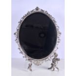 A large dressing table bevelled mirror plated metal with scrolling surround with Cherub supports
