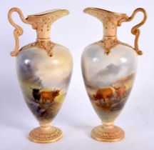 A VERY FINE PAIR OF ROYAL WORCESTER RETICULATED PORCELAIN EWERS C1903 painted with cattle in