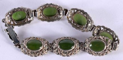 AN ART DECO SILVER AND JADE BRACELET of openwork design. 25 grams. 18 cm long.