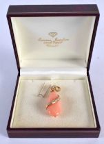 AN 18CT GOLD DIAMOND AND CORAL PENDANT of tear drop form, wrapped with a diamond studded swirl. 9