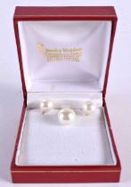 A 14CT GOLD AND PEARL PENDANT with matching earrings. 6.9 grams. Largest 2 cm x 1.25 cm. (3)
