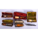 Five Cased Cheroot Holders with Amber Tips and Silver Mounts together with a Silver Cigar Punch (6).