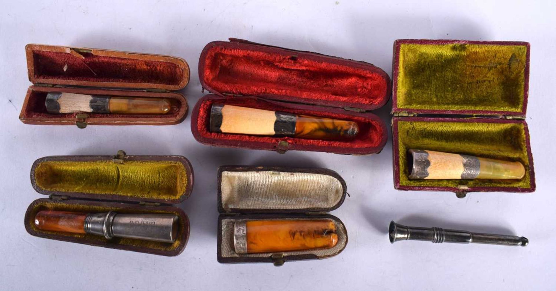 Five Cased Cheroot Holders with Amber Tips and Silver Mounts together with a Silver Cigar Punch (6).
