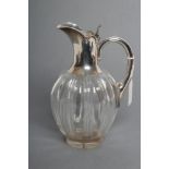 AN EDWARDIAN SILVER MOUNTED CLEAR GLASS CLARET JUG, maker John Grinsell & Sons, Birmingham 1903, the