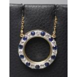A SAPPHIRE AND DIAMOND CIRCLET PENDANT pave set with eleven sapphires and diamonds fixed to a