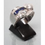 AN ART DECO SAPPHIRE AND DIAMOND COCKTAIL RING, the oblong panel collet set with a brilliant cut