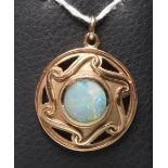 AN ARTS AND CRAFTS STYLE 9CT GOLD BOSS PENDANT centred by a close back set opal doublet(?) within